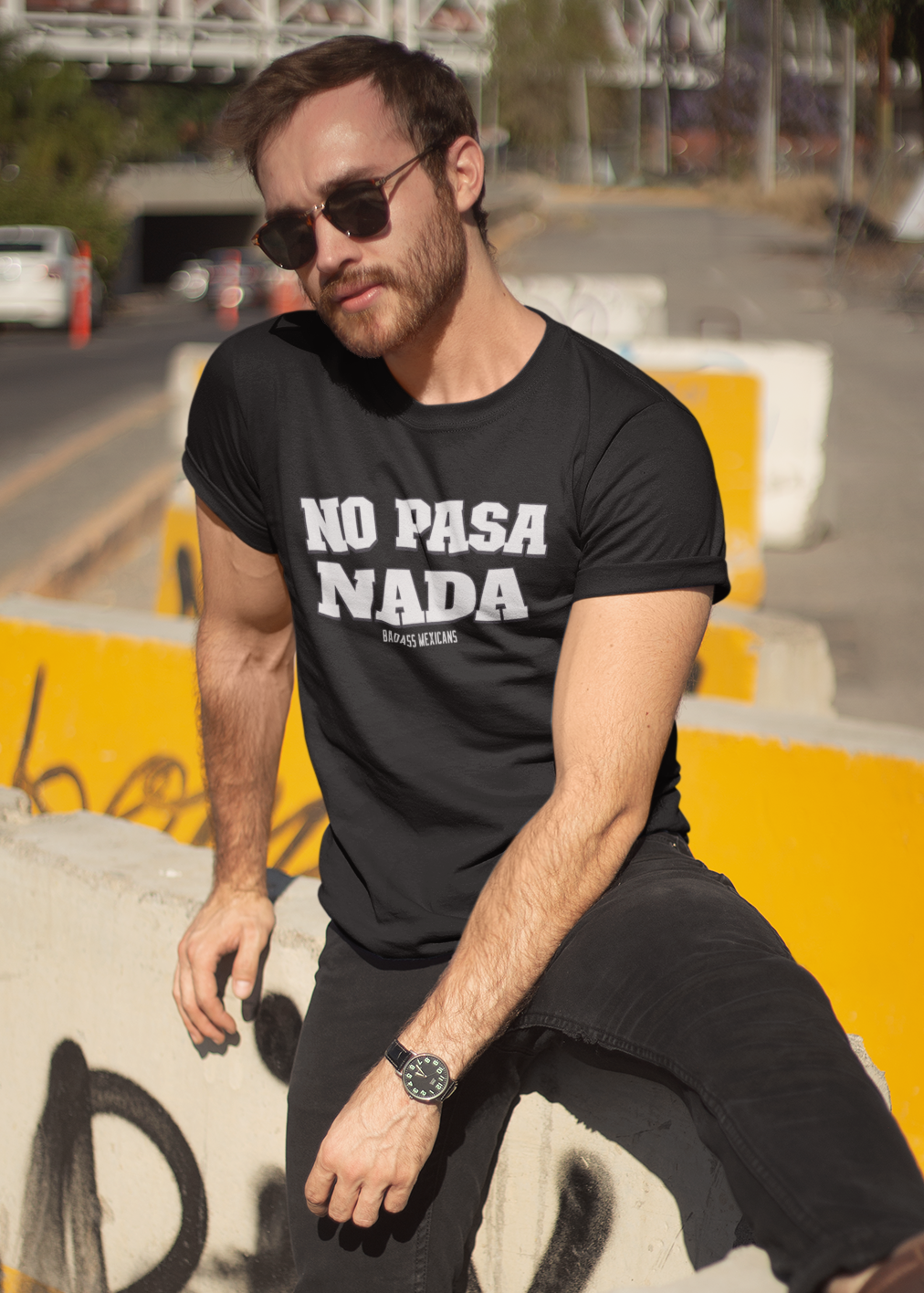 Man wearing a black unisex t-shirt with the phrase “No Pasa Nada” printed in bold white letters