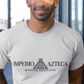 White crew-neck t-shirt featuring the text "IMPERIO AZTECA" in a clean black font, separated by a minimalist line-art icon of an Aztec pyramid.