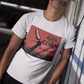White crew-neck t-shirt featuring a red retro movie poster graphic with a hand holding a spiced corn on a stick above a cornfield silhouette.