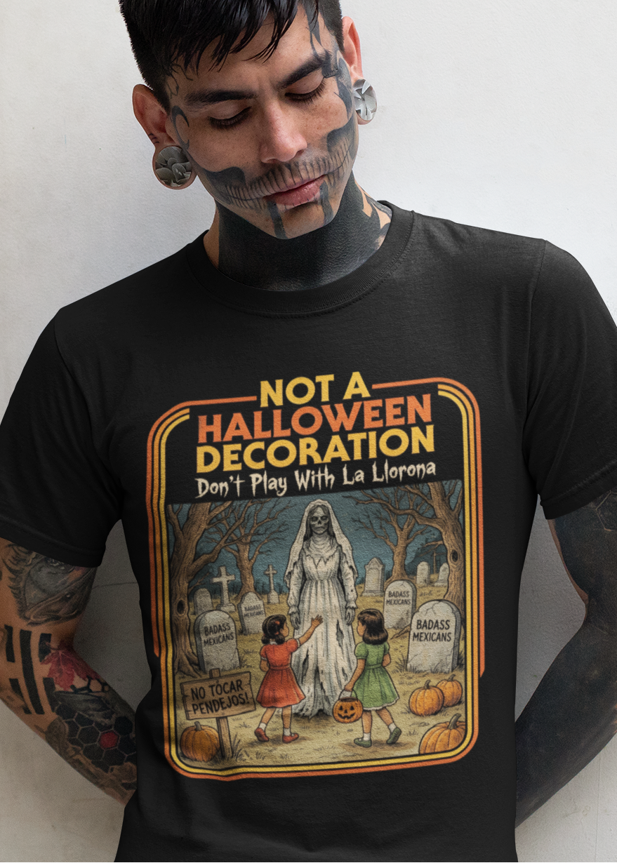 Black t-shirt featuring a retro horror poster illustration of La Llorona in a graveyard above the text "NOT A HALLOWEEN DECORATION Don't Play With La Llorona".