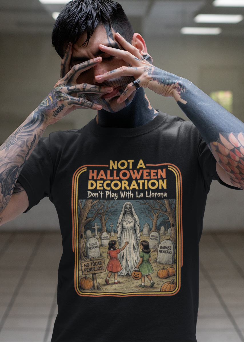 Black t-shirt featuring a retro horror poster illustration of La Llorona in a graveyard above the text "NOT A HALLOWEEN DECORATION Don't Play With La Llorona".