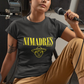 Black crew-neck t-shirt with "NI MADRES" printed in a yellow grunge font above a yellow line-art icon of a smiling man wearing a traditional sombrero.