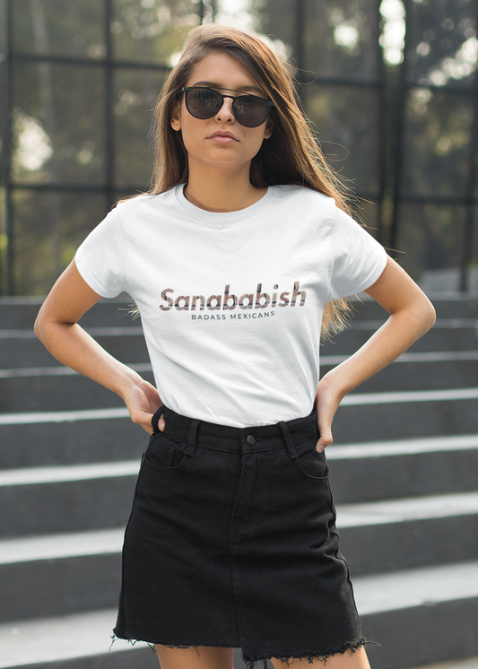 White crew-neck t-shirt with "Sanababish" printed across the chest in a stylized font with a bricks textured pattern, and "BADASS MEXICANS" in small black text below.