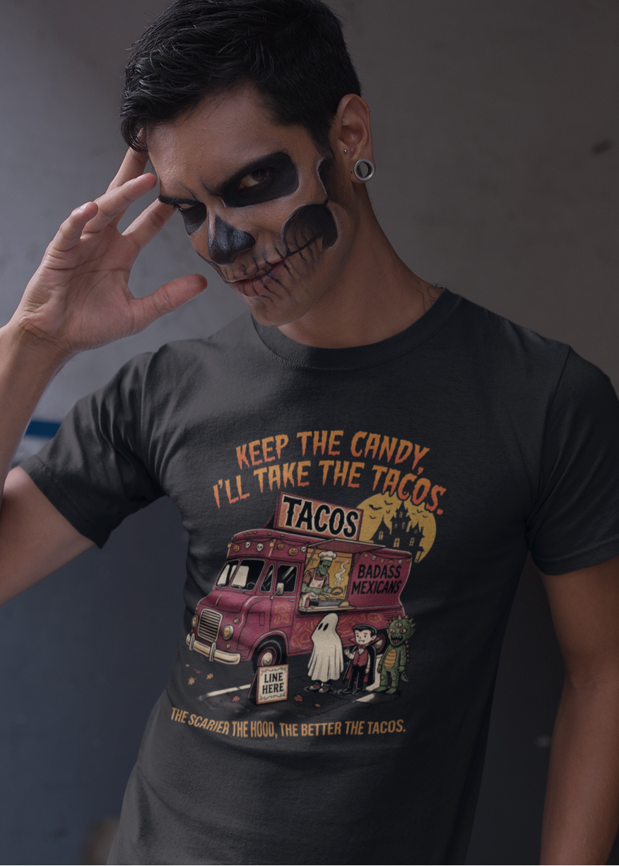 Black t-shirt featuring a spooky taco truck graphic with monsters in line under the text "Keep the candy I'll take the tacos".