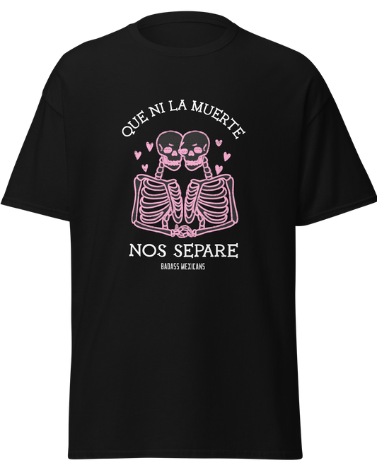 A black unisex t-shirts featuring a pink skeleton couple graphic with hearts and the phrase “Que Ni La Muerte Nos Separe,” 