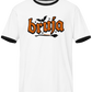 White ringer t-shirt with black collar and cuffs featuring the word "BRUJA" in bold orange font with a bat and broomstick graphic.