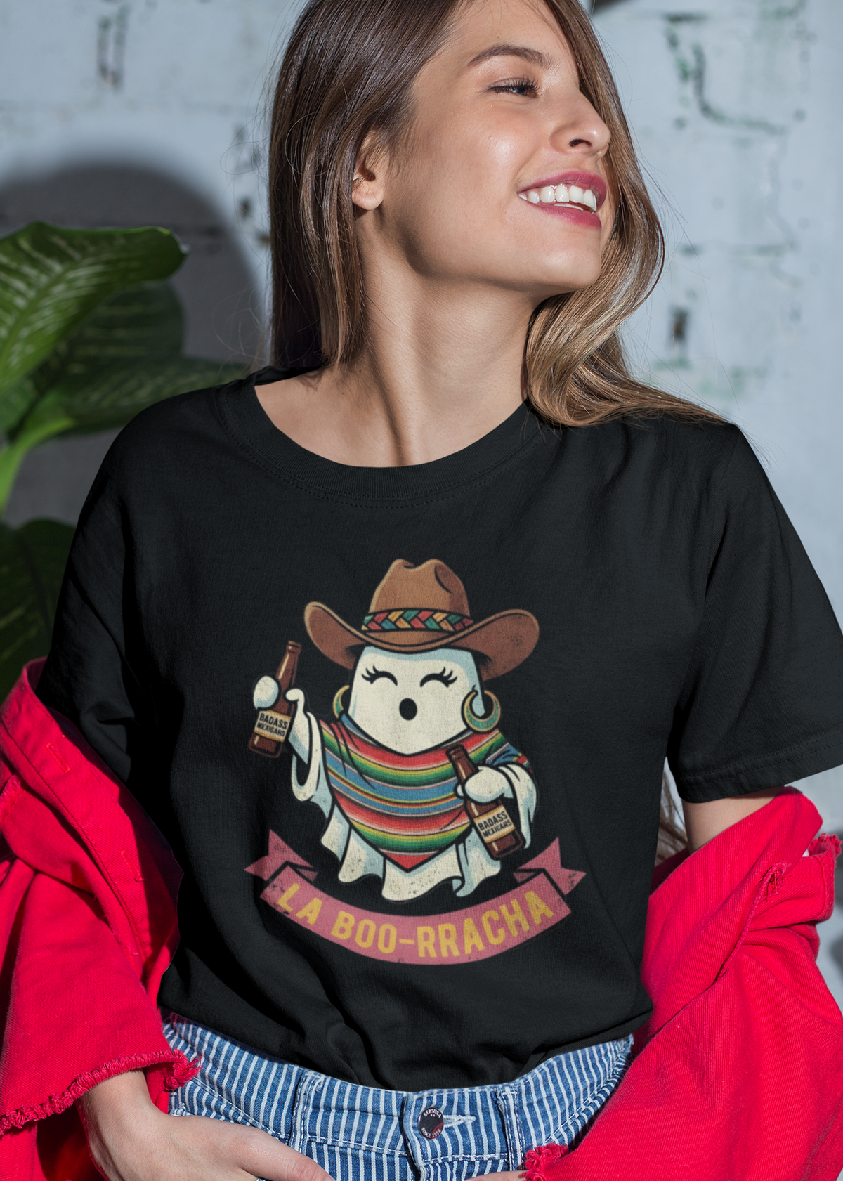 Black fitted women's t-shirt featuring an illustration of a cute ghost wearing a cowboy hat and colorful sarape holding drinks above text reading "LA BOO-RRACHA".