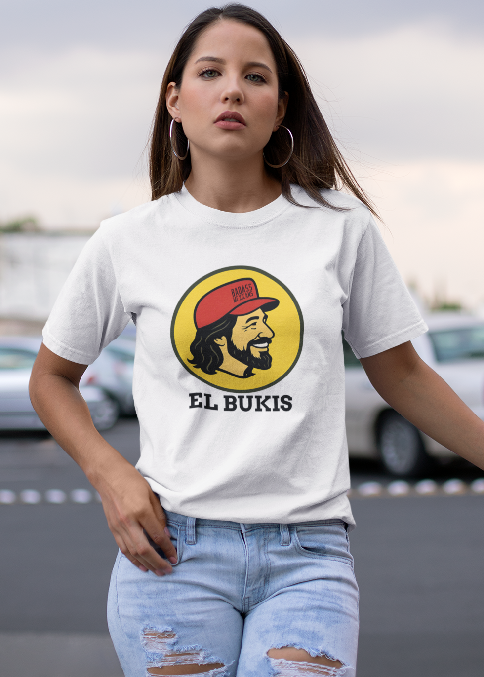 A caricature image of Mexican singer "El Buki," replacing the traditional beaver character on a stylized logo for a gas station.  all printed on a casual, short-sleeved t-shirt. The overall style is a fun, graphic illustration parody.