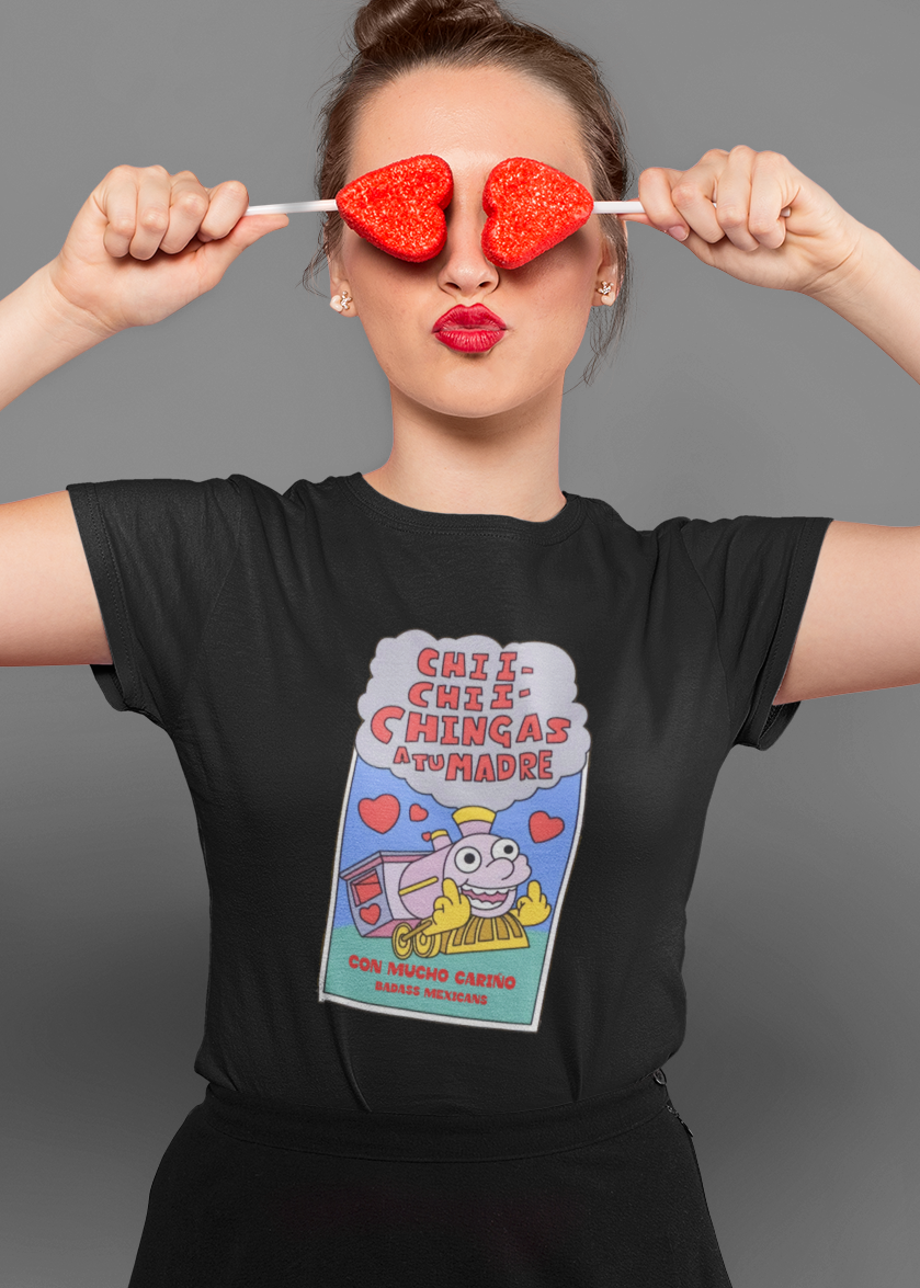 Woman wearing black t-shirt featuring a colorful Valentine-style illustration with Spanish text that reads "Chingas a tu Madre" “Con Cariño,” designed as a humorous and playful Mexican-inspired message.