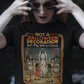 Black t-shirt featuring a retro horror poster illustration of La Llorona in a graveyard above the text "NOT A HALLOWEEN DECORATION Don't Play With La Llorona".